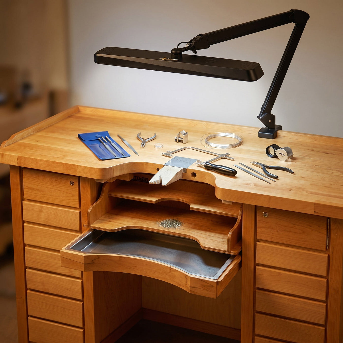 Professional jeweler's bench with Durston LED task lamp. Shop task lighting for metalsmithing and bench work at Otto Frei.